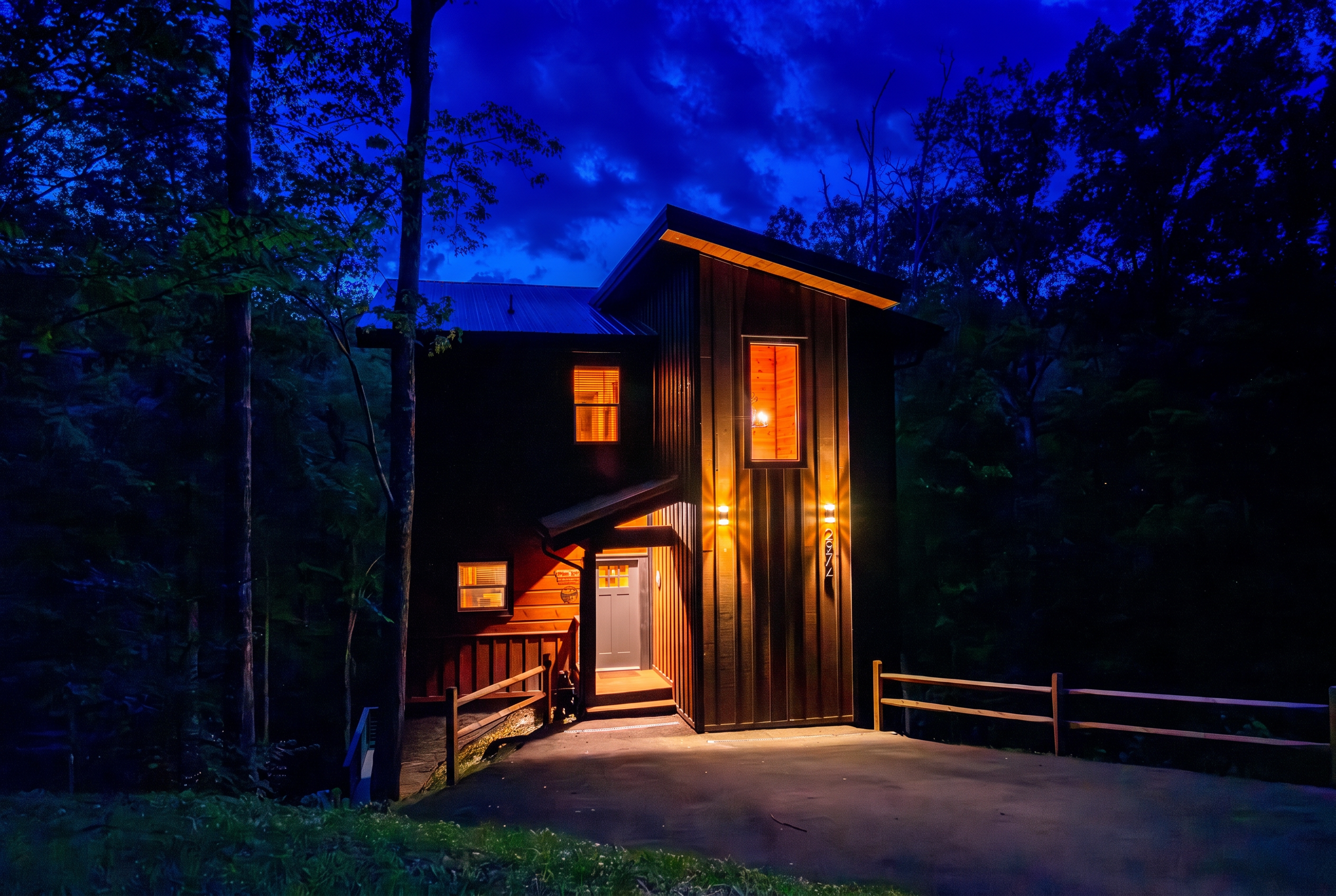Pappa Bear Splash cabin entrance glowing warmly beneath a blue evening sky among the trees